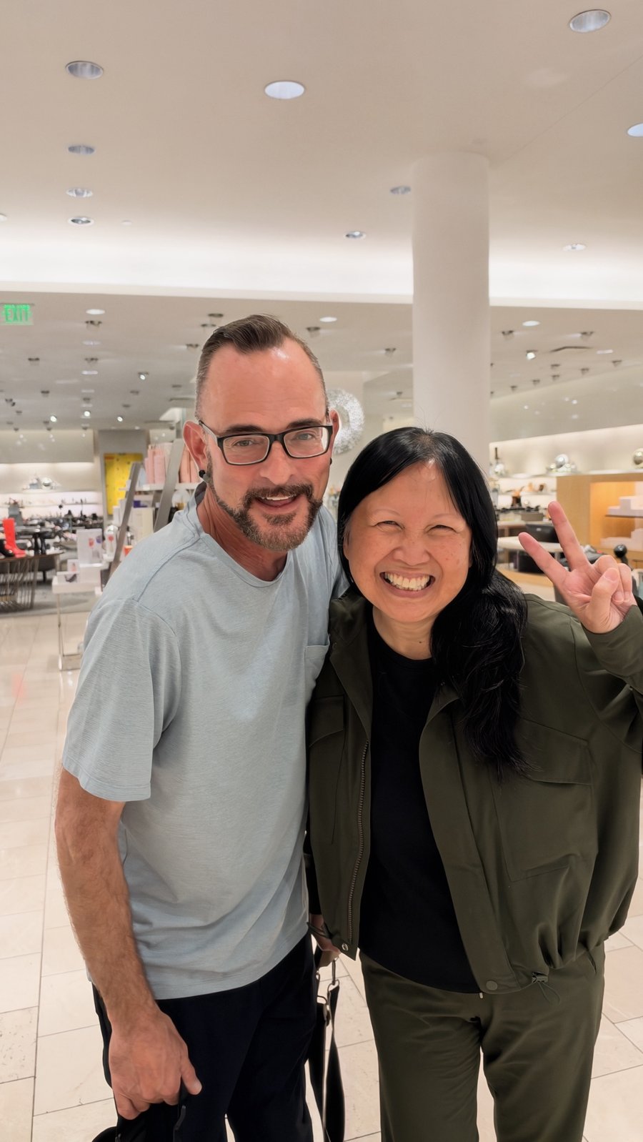 Ken with Kim-Van Dang, who flashes a peace sign, at Neiman Marcus in Atlanta